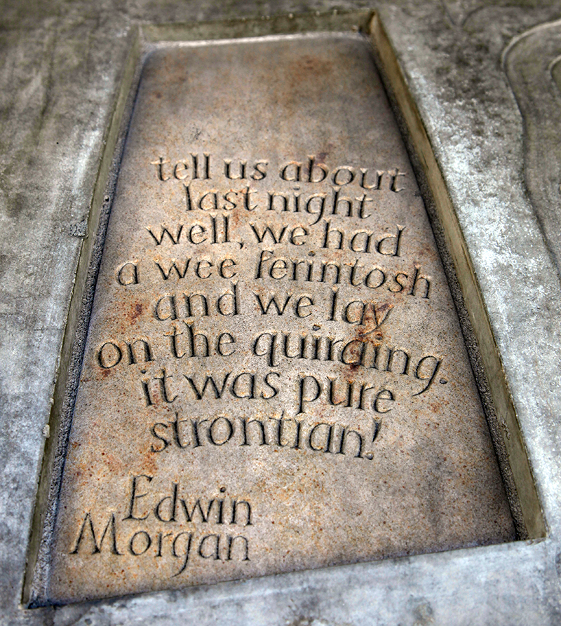 Stone with the following words carved on it: "tell us about last night. well, we had a wee ferintosh and we lay on the quiraing. it was pure strontian! Edwin Morgan"