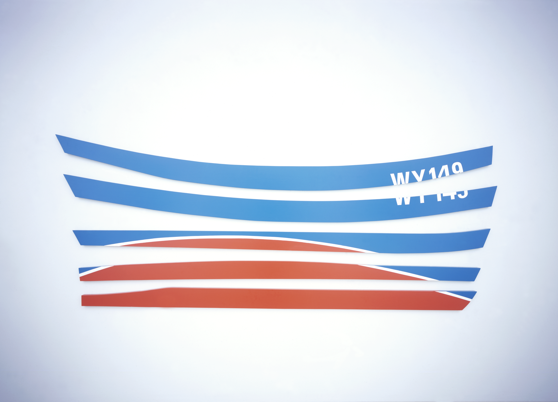 Wooden boat sculpture in five pieces, as if the planks of the boat have been taken apart. 