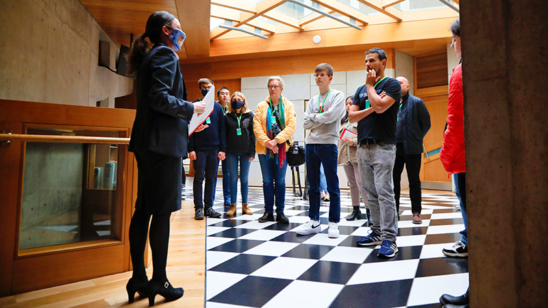 a tour guide stands in front of a group of visitors