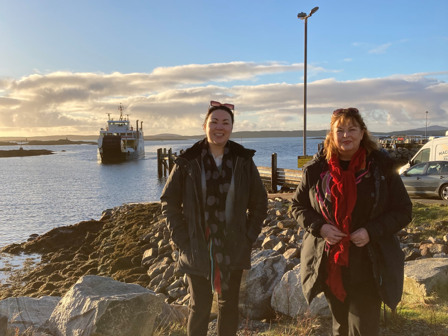 Committee Members wait onshore as a ferry arrives into port.